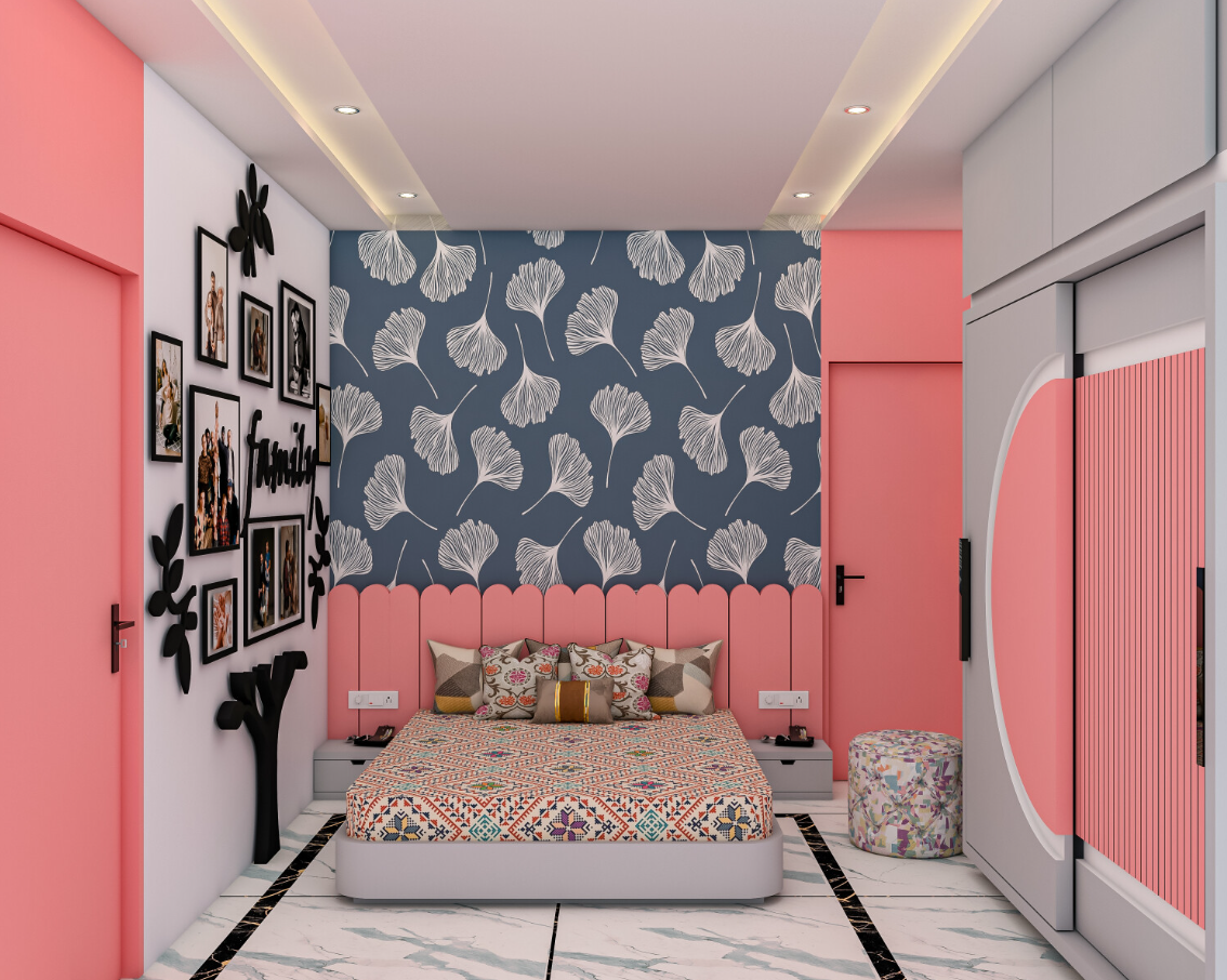 Pink and grey bedroom with floral wallpaper, family photo display, comfortable bed, side tables, and cozy reading nook